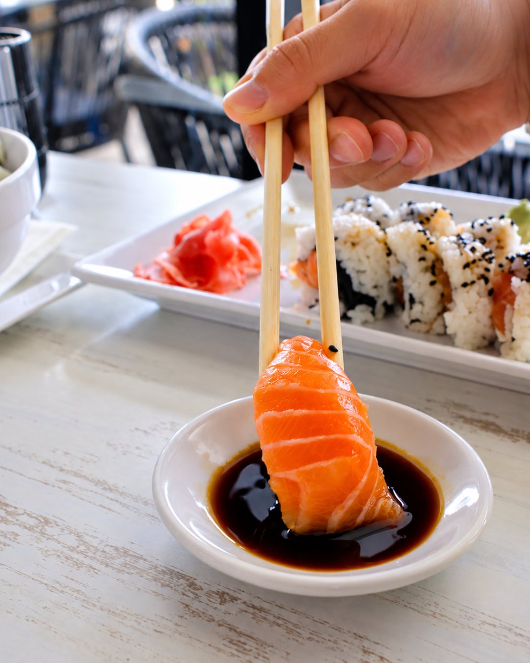 Salmon sashimi dipped in soy sauce